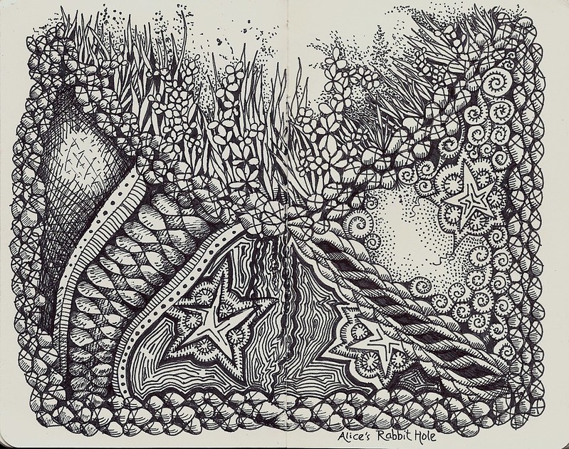 A block and white illstraction of a cross section of topsoil and then underground. There is grass and flowers on top and stones and ropelike rock and starfish-like fossils under the earch.